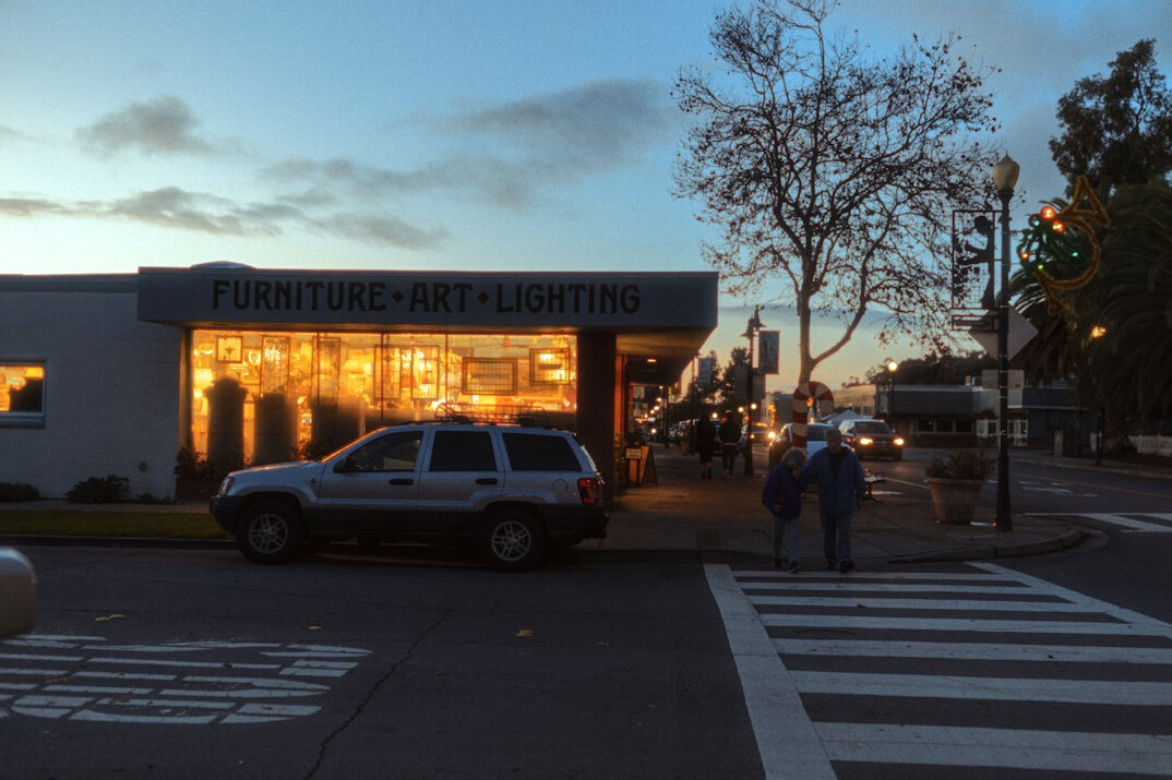 Modern car rental branch storefront at dusk